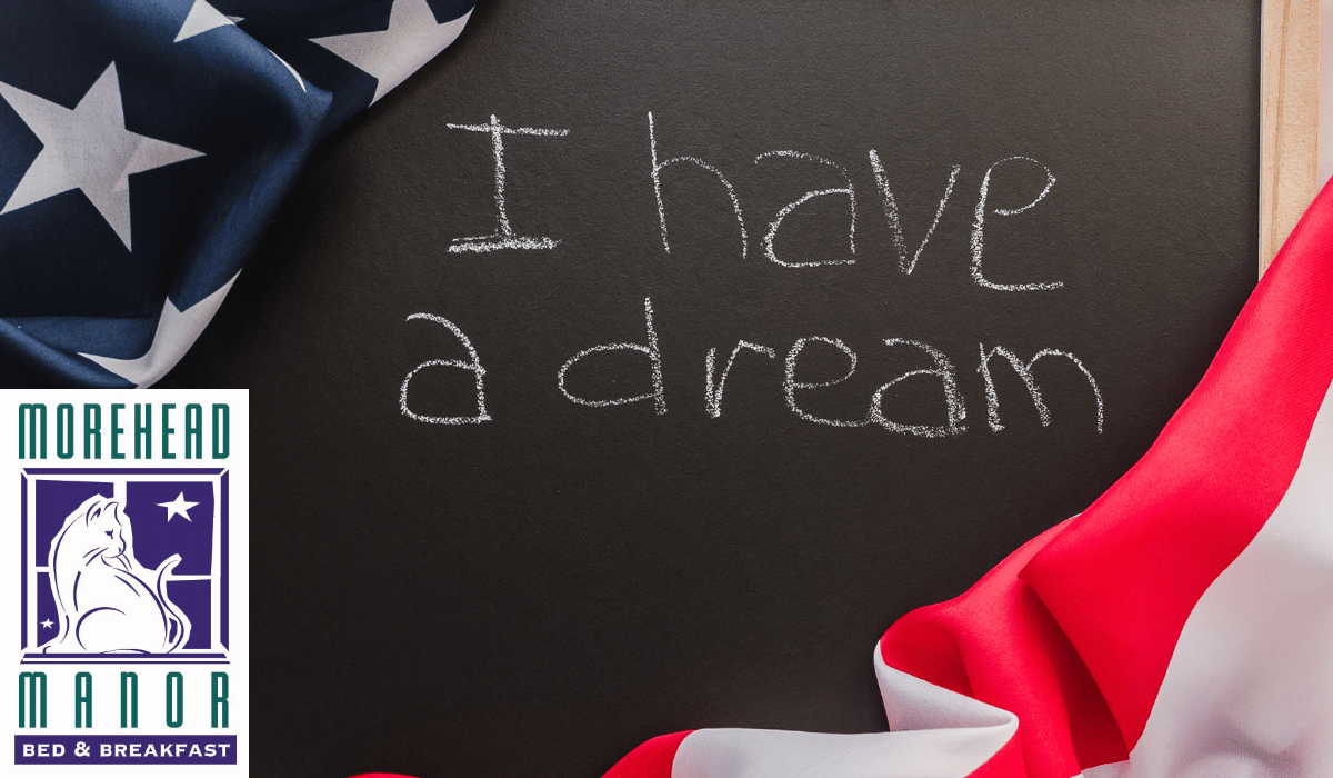 Durham Honors Dr. Martin Luther King, Jr.; I have a dream written on chalkboard next to American flag