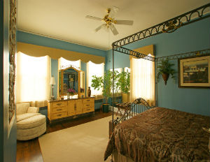 Corner View of King Bed and mirrored dresser in the Tiger room at Morehead Manor